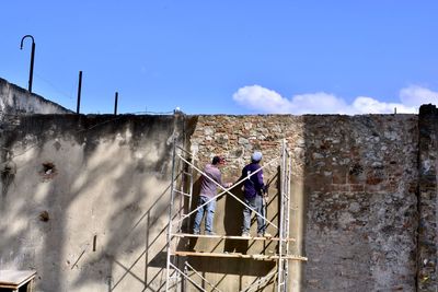 Low angle view of abandoned building against blue sky