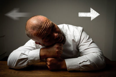 Rear view of a man sitting on floor