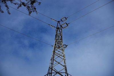 Low angle view of electricity pylon against sky