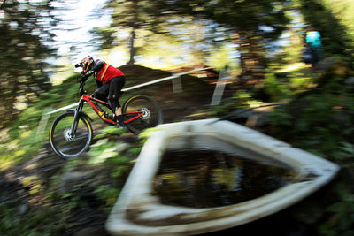 Blurred motion of man riding bicycle