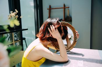 PORTRAIT OF YOUNG WOMAN WEARING MASK