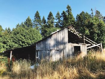 Abandoned built structure on field against clear sky