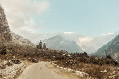 Road amidst mountains against sky