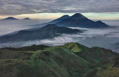 Scenic view of mountains against cloudy sky