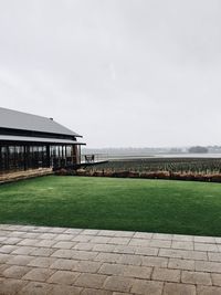 Building on field against sky