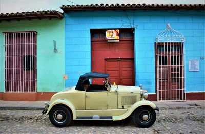 Vintage car on street against building