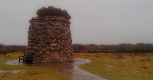 Old ruins on field against sky