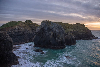 Scenic view of sea against sky during sunset at kynance cove