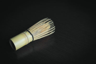 High angle view of paintbrushes on table against black background