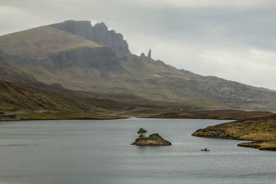 Scenic view of sea and mountains against sky