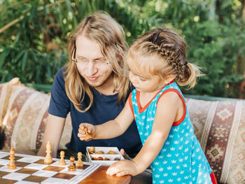 Portrait of a smiling girl playing on table