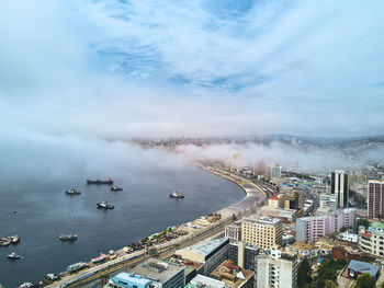 High angle view of buildings by sea against sky