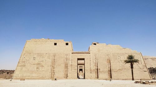 Low angle view of historical building against clear blue sky