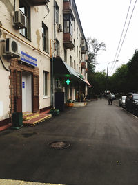 Road amidst buildings against sky in city