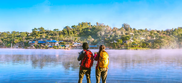 Rear view of woman standing in lake