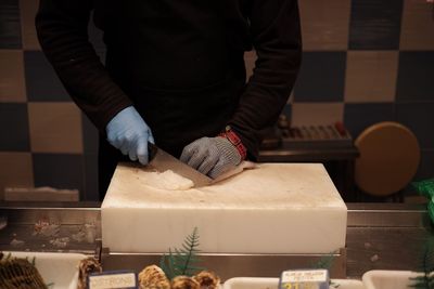 Midsection of man preparing food in kitchen