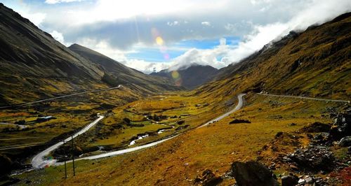 Scenic view of mountains against cloudy sky