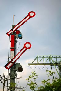 Low angle view of crane against sky