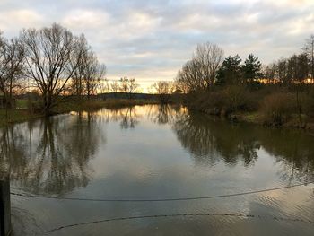 Scenic view of lake against sky at sunset