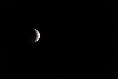 Low angle view of half moon against sky at night