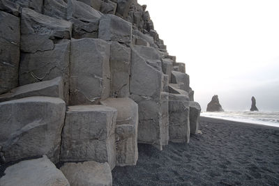 View of stone wall at beach