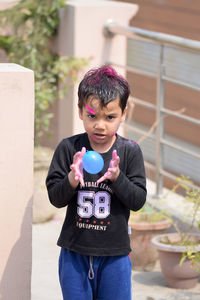 Boy playing with water bomb during holi