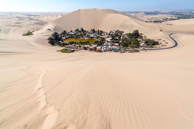 Huacachina against sand dune