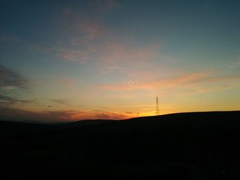 Silhouette landscape against sky during sunset