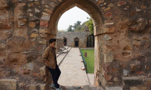 Man seen through archway of historic building