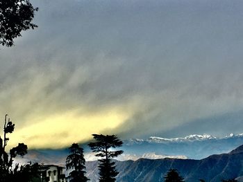 Low angle view of silhouette mountains against sky at sunset