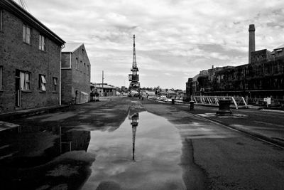 Reflection of buildings in puddle