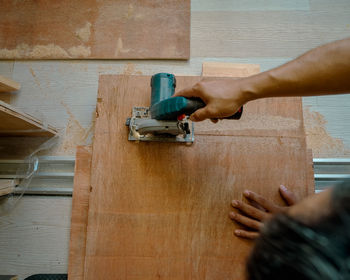 Cropped hand of man working at workshop