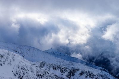 Low angle view of snowcapped mountain against sky