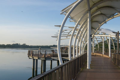 Pier over lake against sky