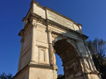 Low angle view of old building against blue sky