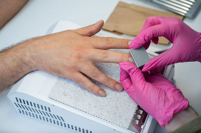 Cropped hands of man working on table