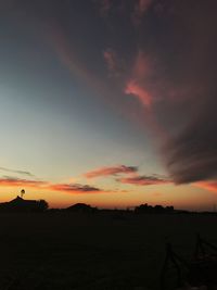 Scenic view of silhouette landscape against orange sky