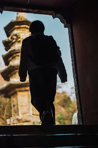 Rear view of man on window of historic building