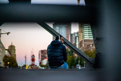 Rear view of man standing in city