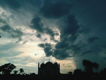 Low angle view of building against cloudy sky