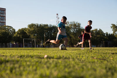 Children playing soccer outdoors field