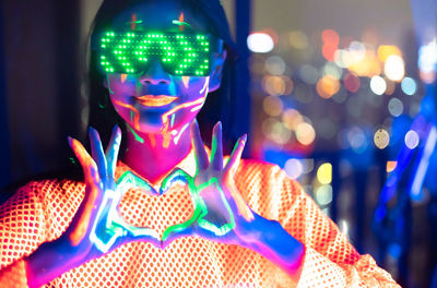 Close-up portrait of illuminated lighting equipment at night