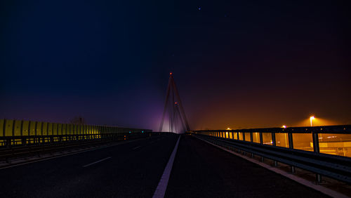 View of bridge against clear sky at night