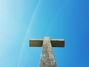 Low angle view of cross against clear blue sky