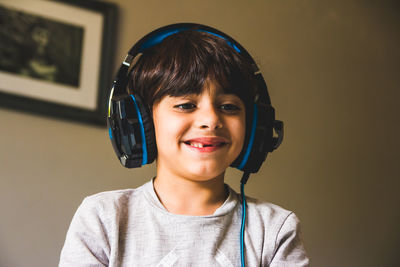 Close-up of smiling boy wearing headphones