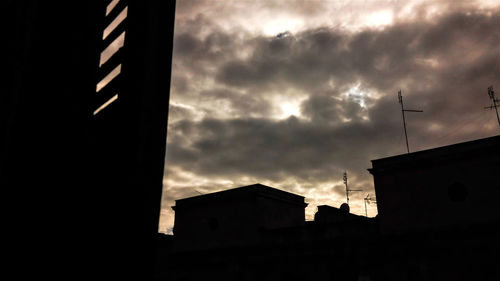 Low angle view of building against cloudy sky