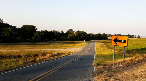 Empty road along countryside landscape