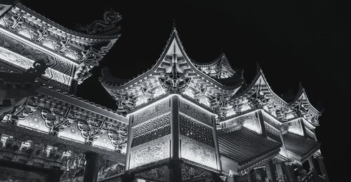 Low angle view of illuminated temple against sky at night