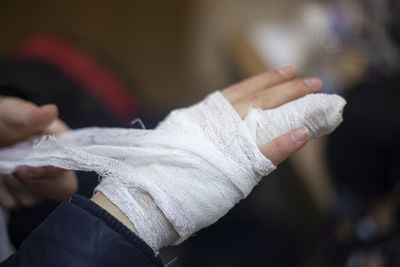 Cropped hands of person with medical equipment and bandage