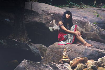 Woman sitting on rock